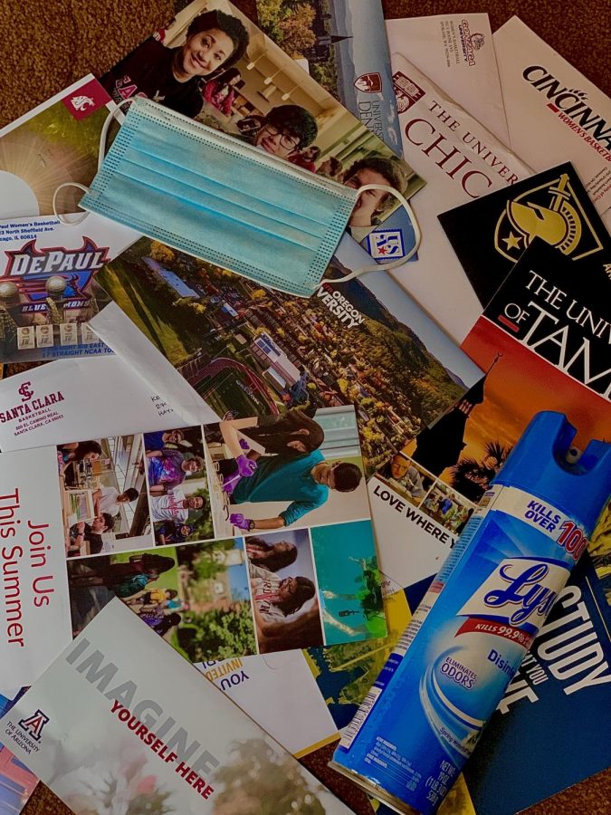 A mask and lysol sits along with many college flyers, one of the only ways students are able to get their college information in the face of the pandemic.