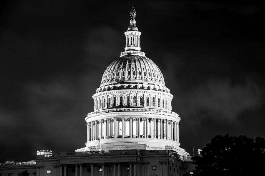 U.S. Capitol building lit up at night.