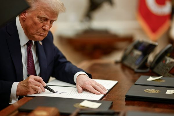 Trump signing an executive order during his first day in office 1/20/2025, taken by the Executive Office of the President of the United States.