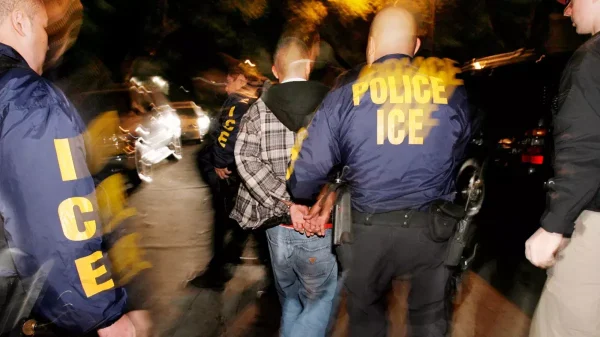 ICE agents carry out a raid in California, operations that have at times mistakenly detained U.S. citizens and fueled widespread fear in immigrant communities. Attributed to Mark Avery.