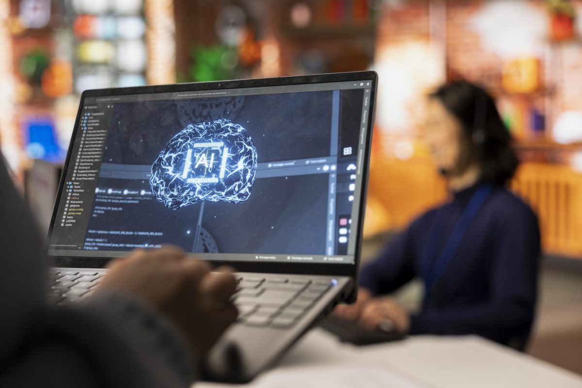 An employee uses AI technology on their laptop. 
