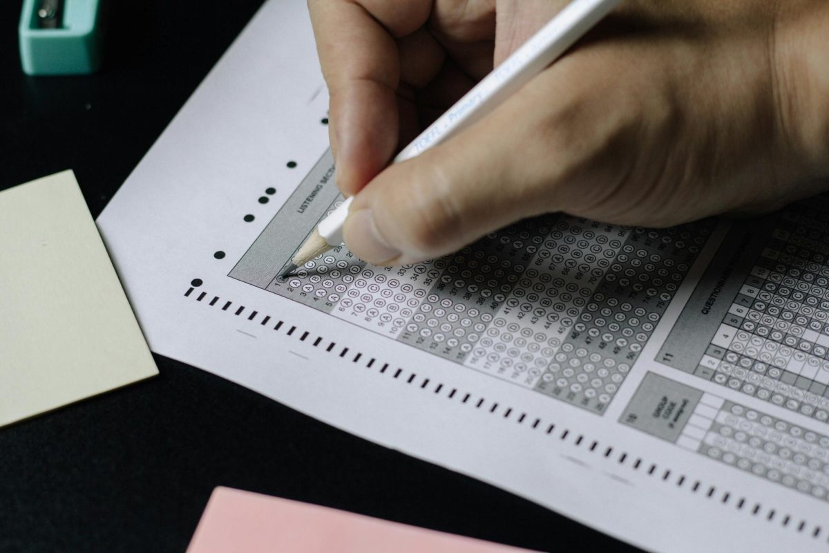 A student fills out a scantron, a key component in a standardized test. 
