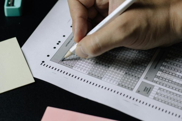 A student fills out a scantron, a key component in a standardized test. 
