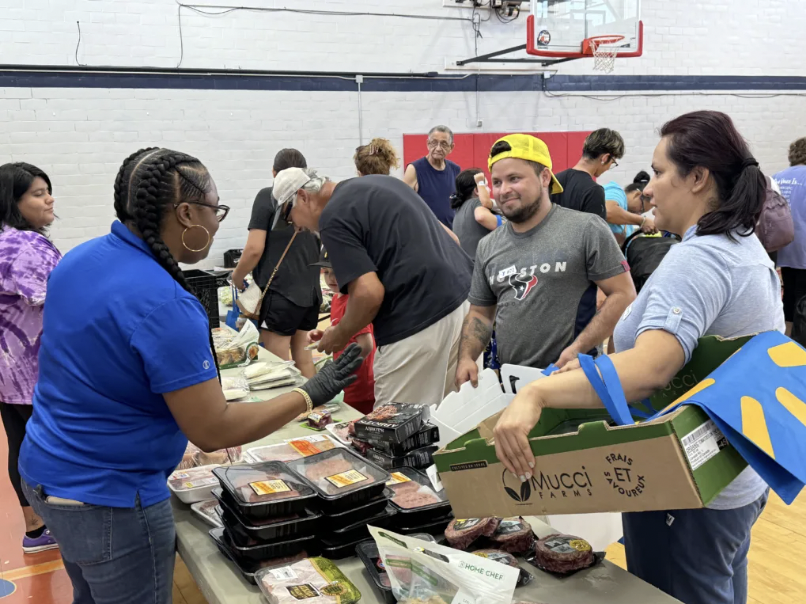 Houston families attend a food drive run by YMCA. 