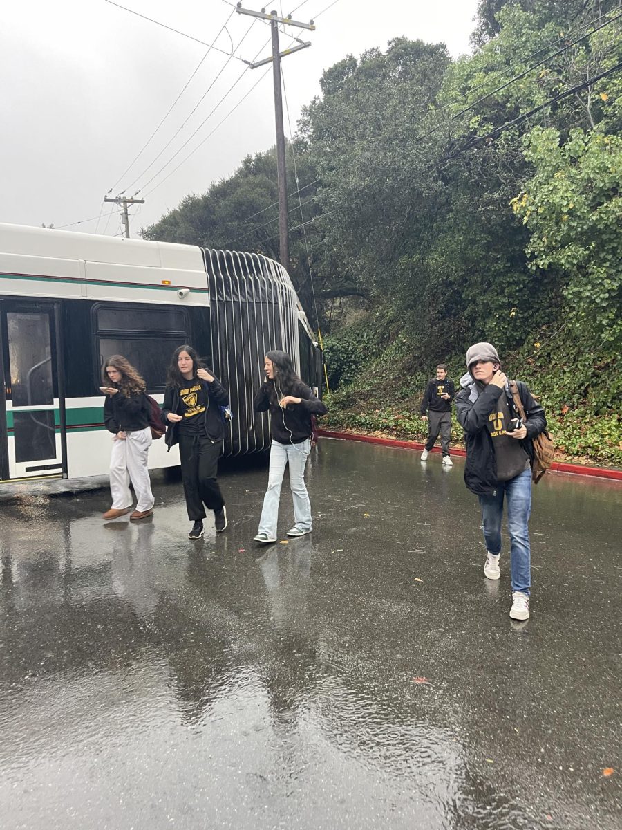 Students exit an AC Transit bus after it crashed into a telephone pole. 